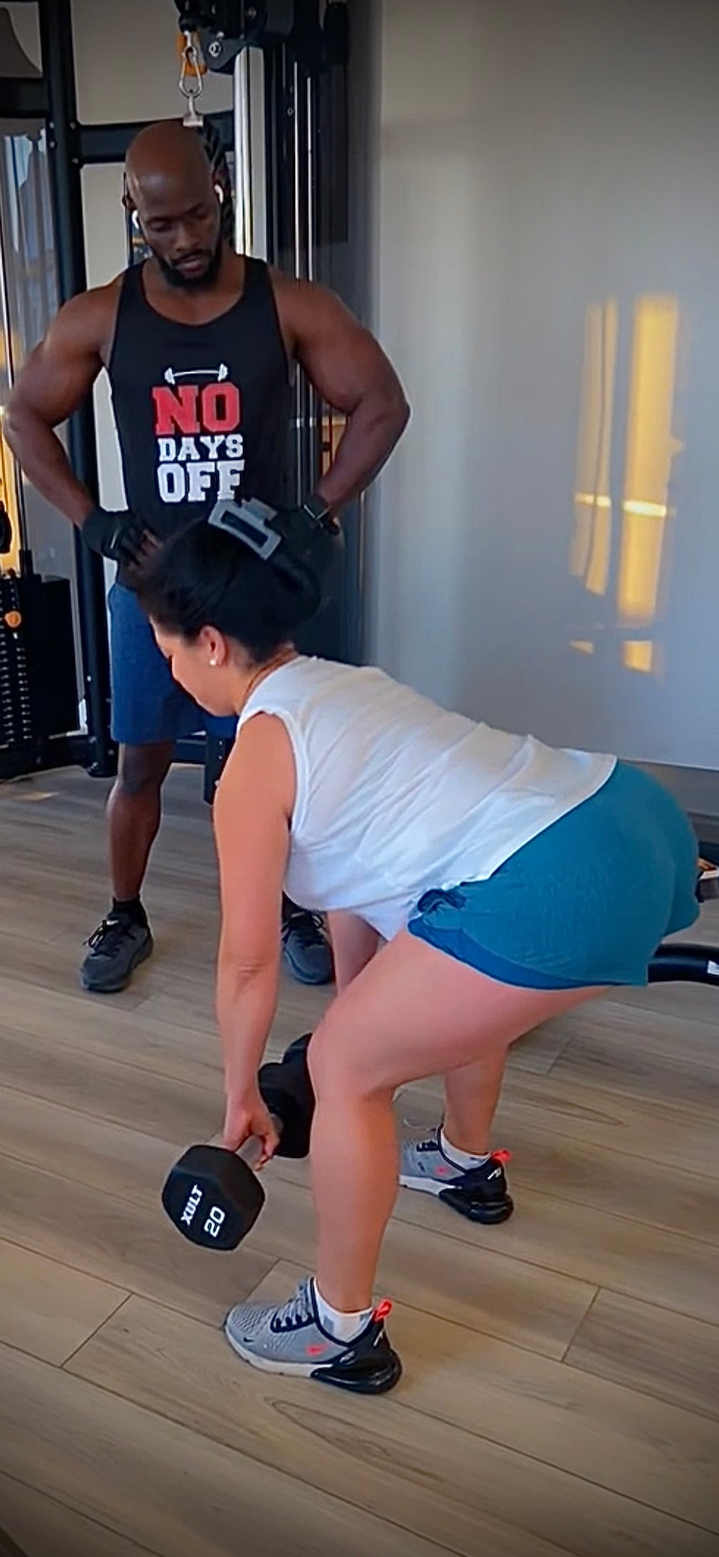 RAMBOfit personal trainer coaching client lifting weights during 1-on-1 online fitness training  